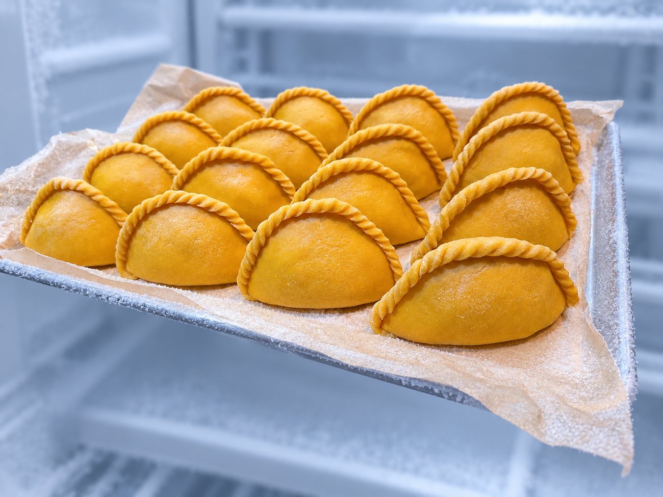 A tray of frozen, ready-to-bake salteñas