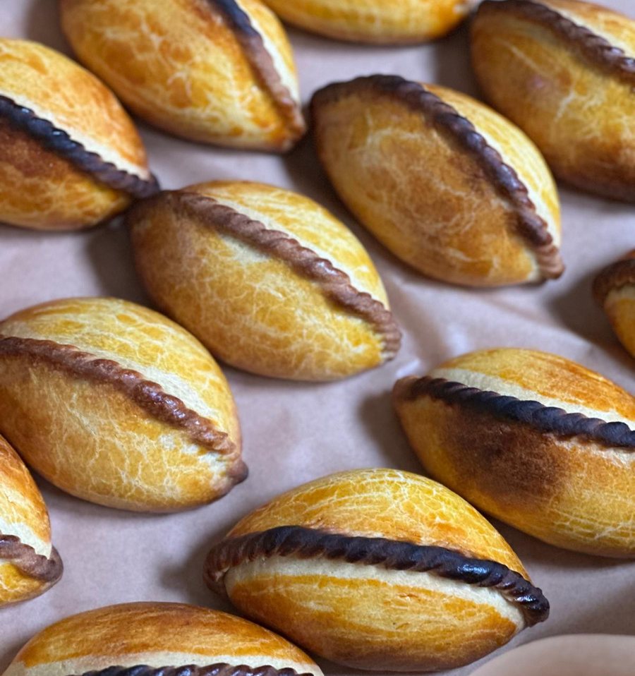 Golden salteñas with a crackled crust
