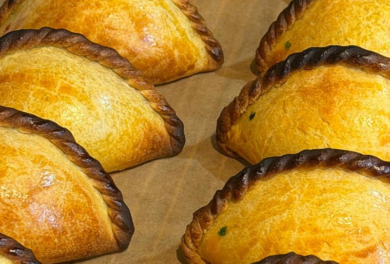 Freshly baked salteñas with braided edges